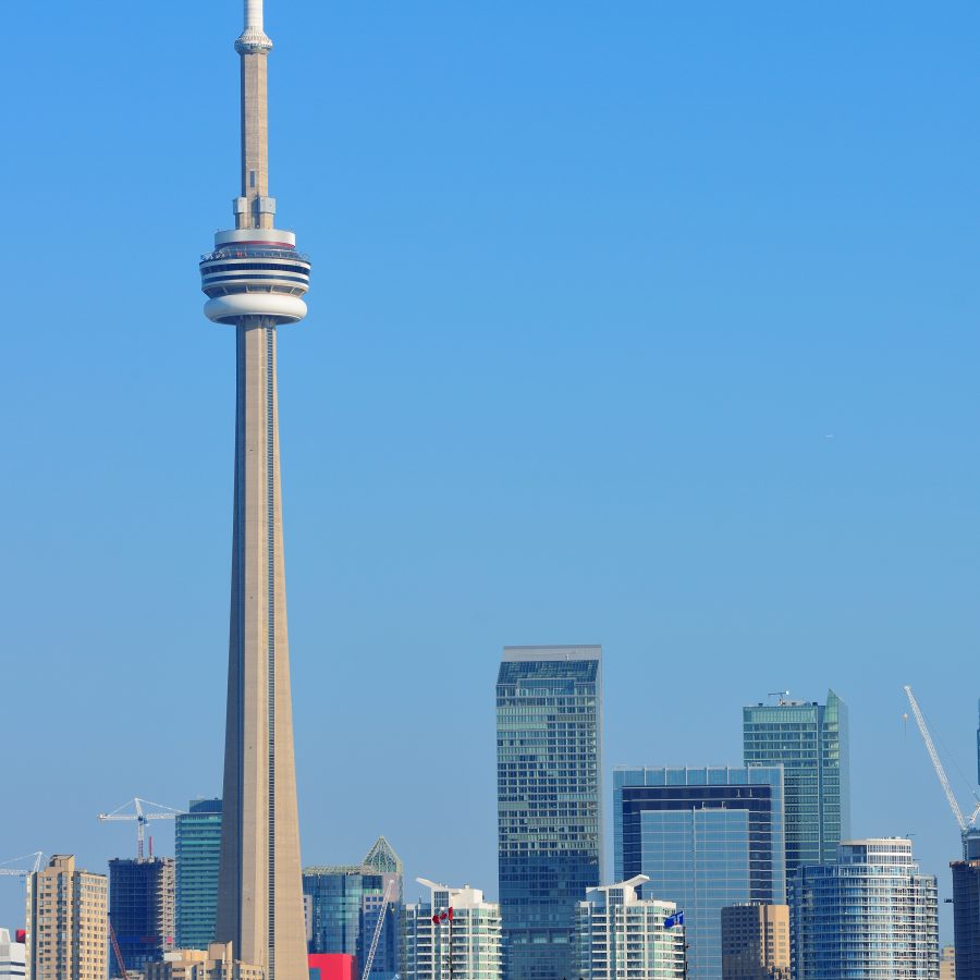 Toronto skyline in the day over lake with urban architecture.
