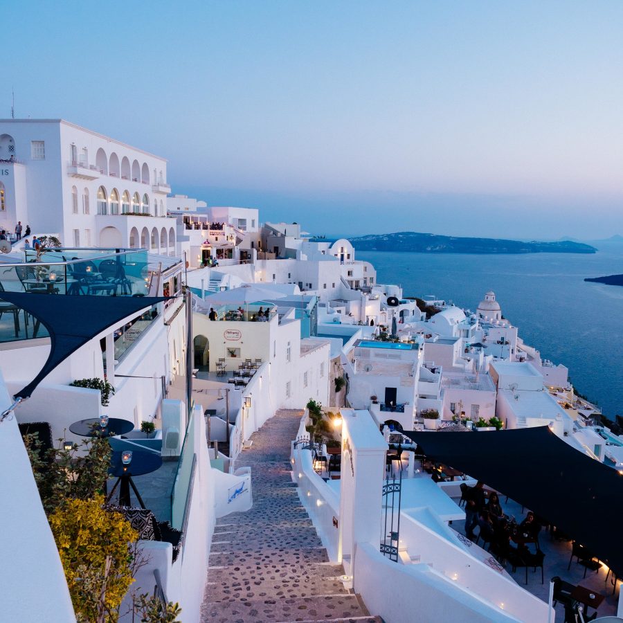 A vertical high angle shot of the white buildings in Santorini, Greece
